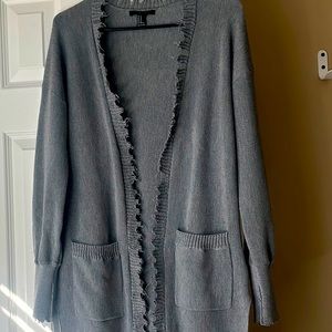 Longline fringe cardigan with slits at sides and two front pockets